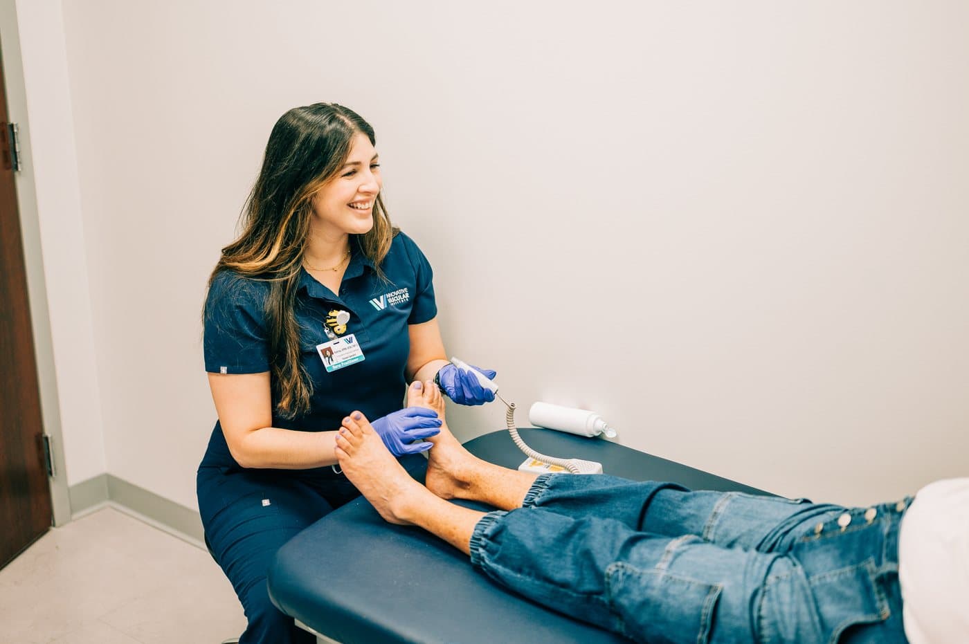 IVI nurse practitioner checking a patient's foot circulation
